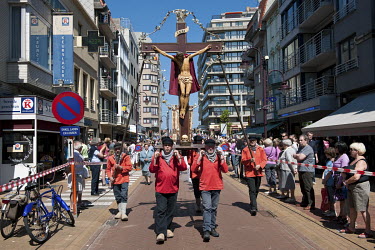 Men carry a large crucifix around the town during a ceremony for the 'Blessing of the North Sea'.