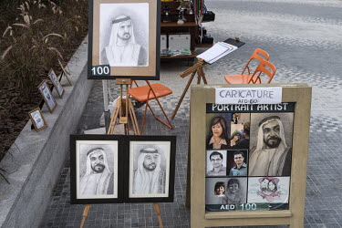 A portait artist's stall displaying pencil drawings of Sheikh Mohammed bin Rashid Al Maktoum, ruler of Dubai, at The Beach, a promenade with restaurants and attractions along the Persian Gulf shorelin...