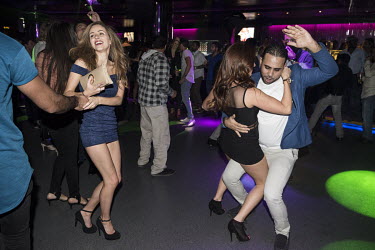 People on the dance floor at a nightclub.