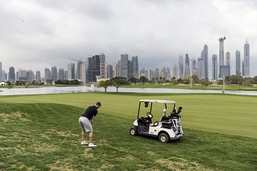 A member takes a swing at the Emirates Golf Club, which, when it opened in 1988, was the first all grass championship golf course in the Middle East.