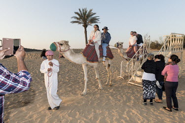 Camel riding for tourists at Al Sahra Desert Resort.