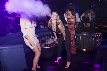 A woman exhales vape smoke at Inner City Zoo, a nightclub at Rixos Premium Hotel at JBR.