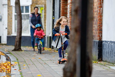 Children riding bicycles and scooters in Dulwich.