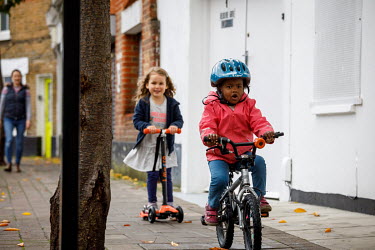 Children riding bicycles and scooters in Dulwich.