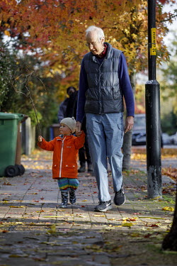 An elderly man walks along a pavement with a child in a Low-Traffic Neighbourhood in Dulwich.