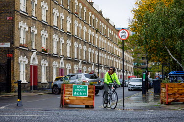 A woman rides a bicycle on a road closed to motorised traffic in Walworth.