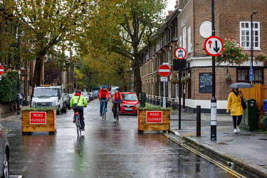 People ride bicycles on a road closed to motorised traffic in Walworth.
