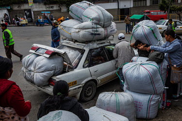 Coca farmers (cocaleros) and traders load their cars with sacks of coca leaves outside Villa Fatima's legal coca market in La Paz.Former President and former coca farmer Evo Morales, forced the Americ...