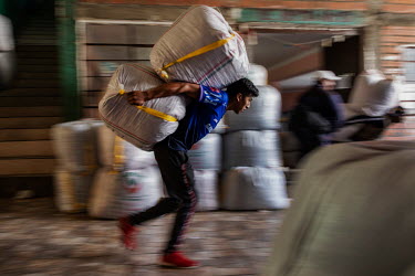 A porter carries sacks of coca leaves at the coca market in the Villa Fatima neighbourhood.Former President and former coca farmer Evo Morales, forced the American DEA to leave Bolivia and introduced...