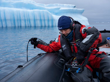 Dr Kirsten Thompson, lead scientist on the Arctic Sunrise uses a hydrophone to listen for whales swimming in waters near an iceberg off Paulet Island at the entrance to the Weddell Sea.  The Greenpeac...