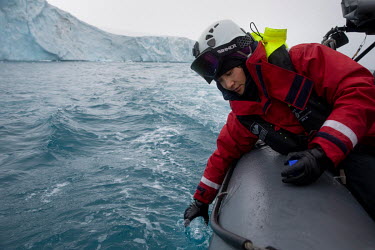 Hsuan Huang, a deck hand from Taiwan, collects water samples from a RHIB near the Arctic Sunrise in the Erebus and Terror Gulf at the entrance to the Weddell Sea.  The Greenpeace ship Artic Sunrise wa...