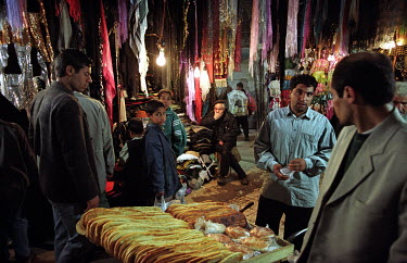 A man selling bread in the city bazaar.