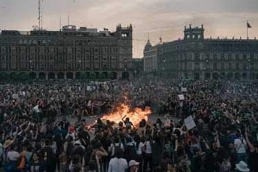 Demonstrators gather around a fire made out of wood barriers, aerosol spray cans, banners and bras in the Zocalo Plaza on International Women's Day. The annual demonstrationÂ�intensified and turned i...