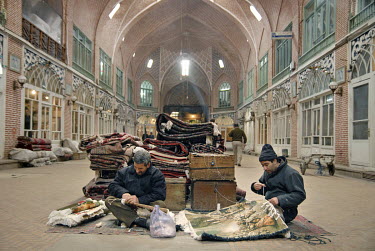 Two men weaving carpets in a karavansaray in the city's old bazaar.