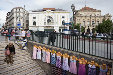 Night dresses displayed on a stairway leading to a pedestrian underpass on Place du 1 Novembre in the city centre. The white building in the background is the a branch of the National Bank.