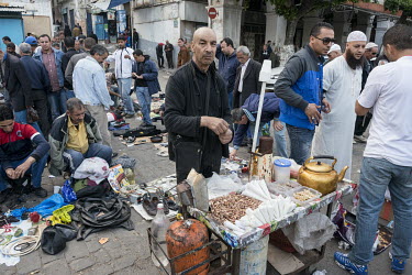 A street vendor selling nuts at a flea market at the entrance to the lower casbah near Bab El Oued.