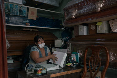 Guadalupe Marquez (48) arranges paperwork at her funeral home opposite a public hospital in Iztapalapa.