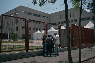 People hold hands while praying outside the Belisario Dominguez Hospital in Iztapalapa where patients with suspected COVID-19 are treated. The Iztapalapa municipality has had the highest number of COV...