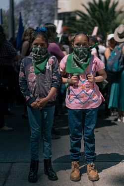 Tana Olarte (11) and her sister Renata Olarte (9) together on Avenida Juarez on Women's Day. Tana: ''We come to ask for justice, for all those who have been killed.'' ''We wear a bandana so they don't...