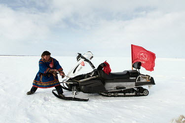 Eyko, a Nenets activist who flies a communist party flag from his snowmobile, starts his vehicle's engine. He created an internet media site called 'Golos Tundri' (Voice of the Tundra) that seeks to u...
