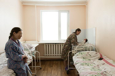 Larisa (R), who lives out on the Tundra, with her new born child at the town's maternity hospital. If a woman has health complications and cannot get to the hospital on her own, a medical helicopter f...