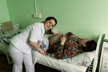 Medical worker Tatyana uses a Pinard stethoscope to listen to the unborn foetus of a pregnant Nenet woman at the town's maternity hospital. If a woman has health complications and cannot get to the ho...