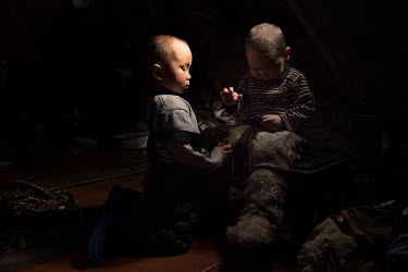 Nenets children Gosha and Tisha playing inside their tent ('chum').