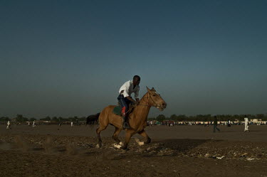 A stable hand takes a horse for a training gallop at the city's racecourse two days prior to the Grand Prix BEAC (The Bank of Central African States), one of the major meetings of the year.