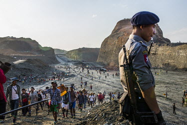A policeman blows the whistle to signal the end of the daily two hour period during which freelance miners can work in the Yadanar Yaung Chi jade mine in Hmaw Si Zar. Each day, from 4 to 6pm, the comp...