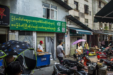 A sign outside one of the shops at the Yuyu unofficial jade market reads: 'We welcome friends from Myanmar to send raw jade stones'. The market that serves as the trading place for raw stones smuggled...