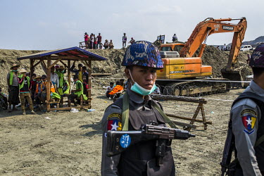 Police guards at a jade mining site where the collapse of a huge lake of sludge killed at least 55 workers from the companies operating at the site in Hmaw Warn Lay.