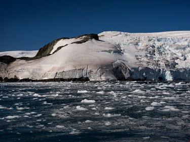A glacier flows into the icy waters in Discovery Bay, Greenwich Island, in the South Shetland Islands.  The Greenpeace ship MY Esperanza is on the final leg of the pole to pole voyage from the Arcti...
