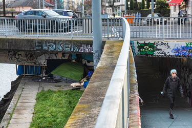 Tents of the homeless hidden from sight under one of the bridges across the Rhone River as it runs through Geneva.