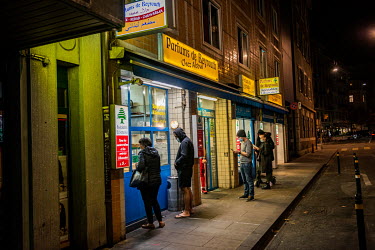 A socially distanced queue outside a Lebanese kebab restaurant, waiting for take away, in Geneva's multi-cultural Paquis district during the second wave of the COVID-19 pandemic which saw eat-in resta...