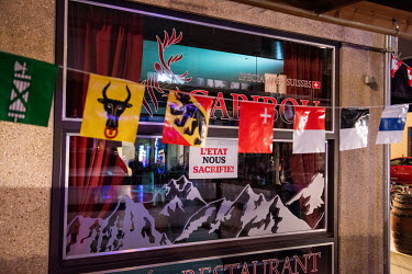 A protest sign in the window of a closed restaurant reads 'The State is sacrificing us'. The restaurant, in Geneva's multi-cultural Paquis district, has been closed to eat-in customers during the seco...