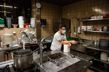 Andriulo works alone in his restaurant's kitchen during Geneva's second lockdown during which restaurants have been permitted to stay open, but only for take away service. Andriulo has had to lay off...