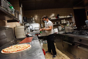 Andriulo works alone in his restaurant's kitchen during Geneva's second lockdown during which restaurants have been permitted to stay open, but only for take away service. Andriulo has had to lay off...