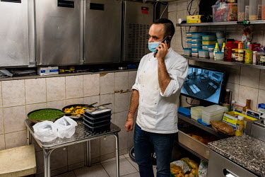 Ash taking an order for two take away meals in the kitchen of his restaurant, Le Dhaba, during Geneva's second lockdown in which restaurants have been permitted to stay open, but only for take away se...