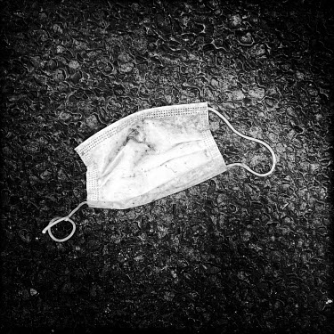 A discarded facemask, photographed on the streets of Berlin. Facemasks have become mandatory in public spaces in Germany in the course of the corona virus pandemic of 2020.