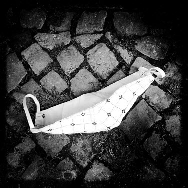A discarded facemask, photographed on the streets of Berlin. Facemasks have become mandatory in public spaces in Germany in the course of the corona virus pandemic of 2020.
