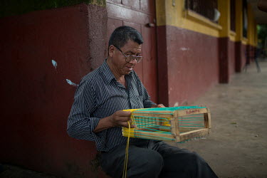 War survivor Roberto Gonzalez, 52, weaves a plastic basket at the Jose Marti Federation school, current shelter for the Fuego Volcano-affected community members from La Trinidad. A local Rotay Club-sp...