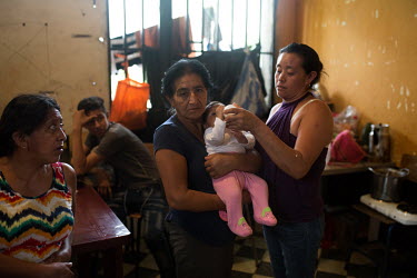 Adilia Diaz, 59, holds her great-granddaughter Abigail, while her daughter Rosalina Montejo Diaz (right) holds the bottle. Adilia and Rosalina are war survivors who have now spent over three months at...