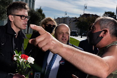 Opposition judge Igor Tuleya (centre), outside the Polish Supreme Court building with his defenders, Jacek Dubois and Michal Zacharski (right), argues with a government supporter.