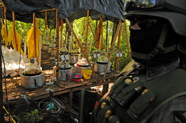 Soldiers guard chemicals and laboratory equipment at a remote crystal meth (methamfetaimne) lab which the army are to burn down a few days after it was first raided.