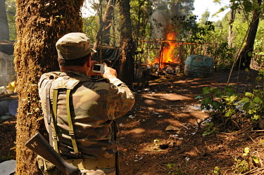 A soldier records as a crystal meth (methamfetaimne) lab is burned down by the army a few days after it was first raided.