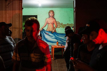 A mural of a naked woman at the crowded entrance of a brothel on a payday for the Belo Monte dam construction workers.