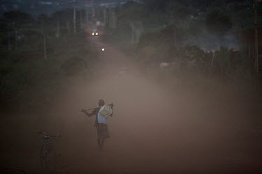 A man walks along the Trans-Amazonian highway in the outskirts of Altamira.