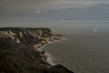 The white cliffs between Folkestone and Dover. At right, a ferry leaves Dover for France.