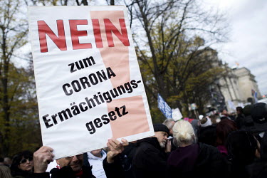A protester holds a placard that reads: 'No to the Corona Authorization Act' during a protest against lockdown measures and other government policies relating to the novel coronavirus crisis.