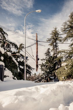 An electricity pole dramatically damaged and hanging from the power wires as about 45 cm of snow covers the ground in the northwest outskirts of the city after it was was hit by Filomena, the stronges...